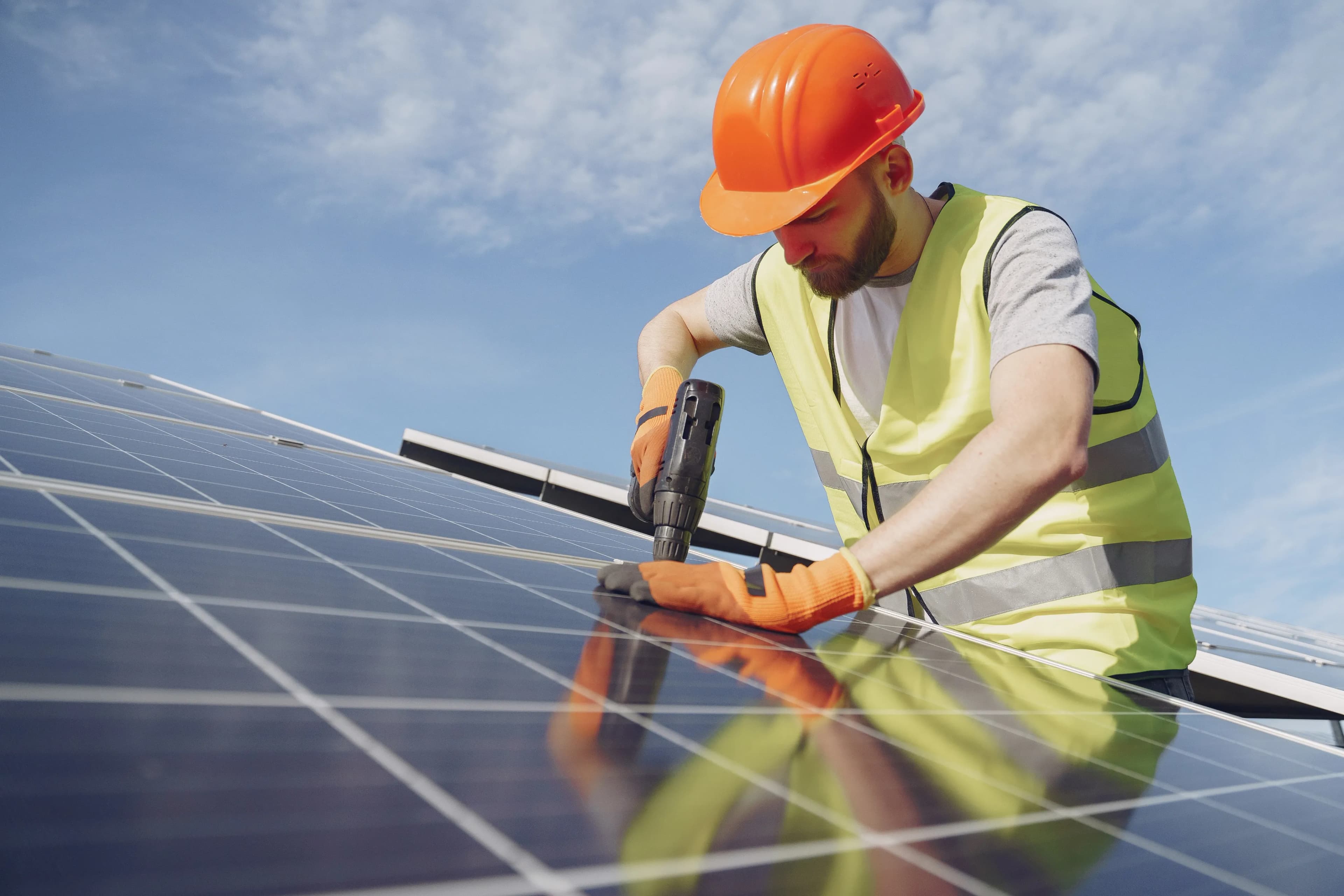 worker installing solar panels